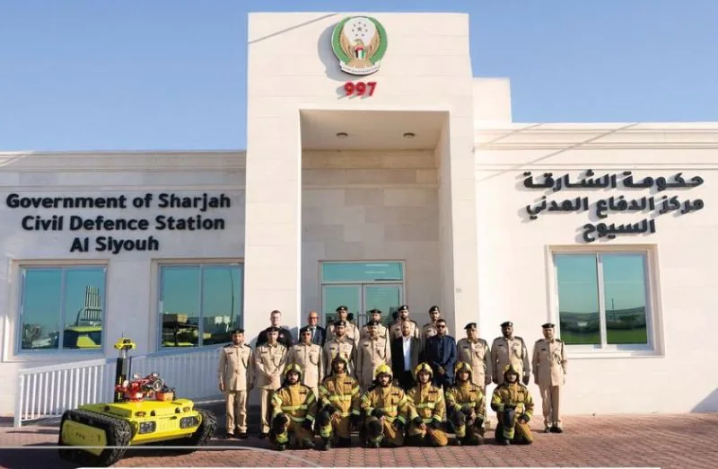 Crew photo with the robot outside a civil defence station