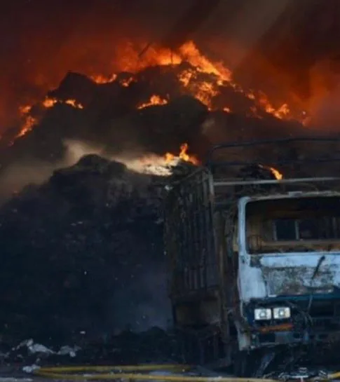 Fire scene: burning pile and truck