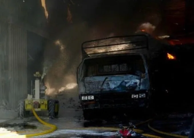 Robot working beside a burned truck